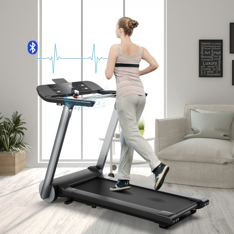 Folding treadmill with LED display and heart rate monitor, ideal for home workouts and easy storage.