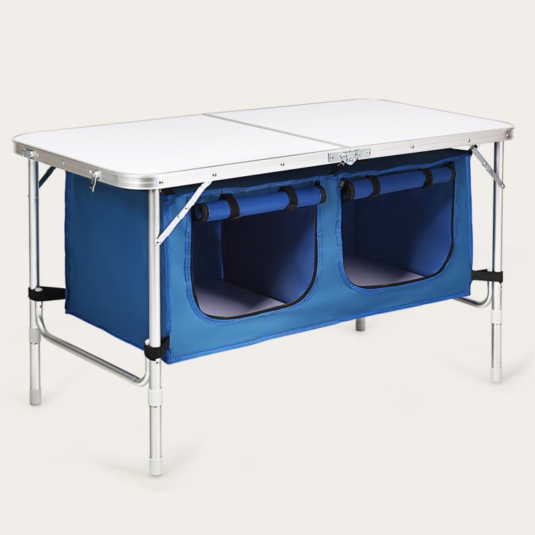 Height adjustable blue folding camping table with large storage area and compact design, ideal for outdoor activities.