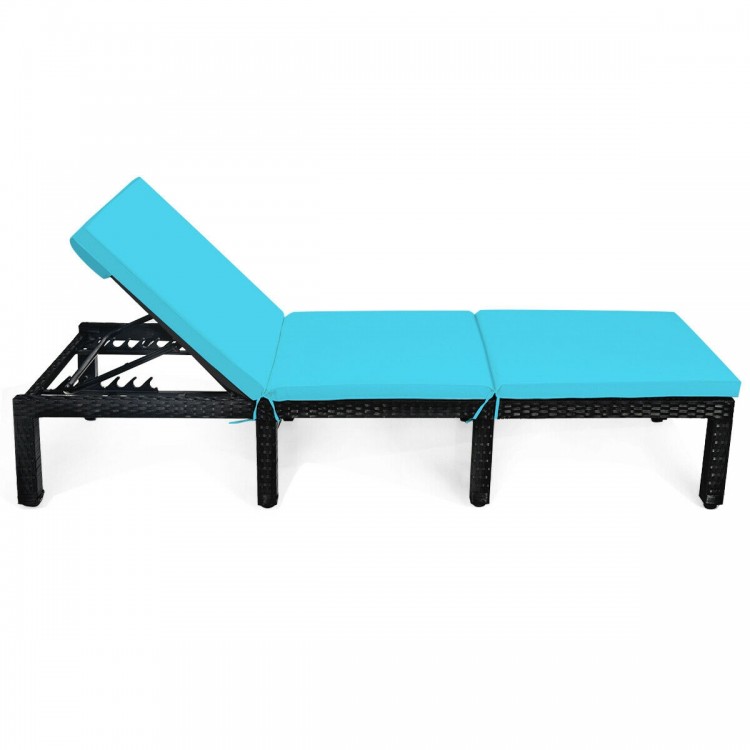 Height adjustable rattan lounge chair with blue cushion, designed for outdoor use at patio or poolside.