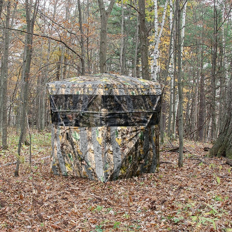 3-person portable tent with real wood camouflage, featuring multiple windows for a wide field of view in the forest.