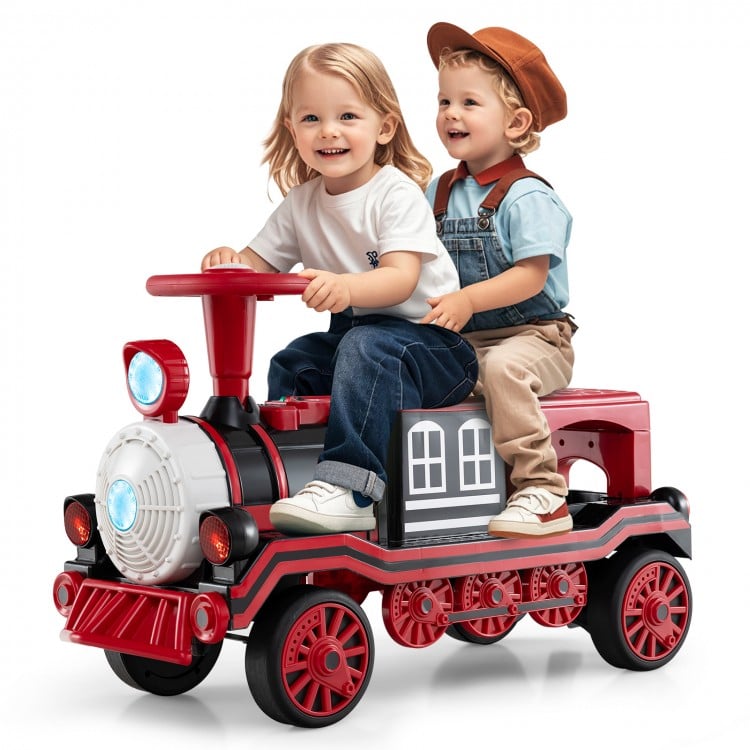 Two children riding a red 12V train toy with removable chair, featuring a steering wheel and fun sound effects.