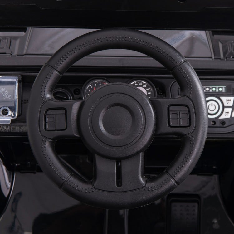 Anti-slip steering wheel of the 12V electric kids ride-on truck with remote control, designed for easy operation.