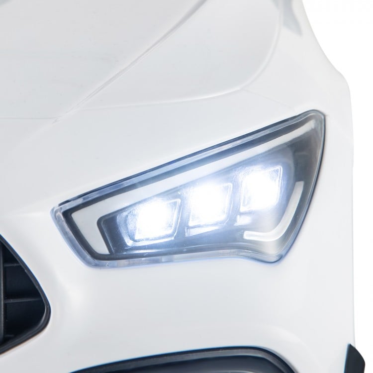 Close-up of the white Mercedes-Benz AMG CLA 45 kids ride-on car's LED headlights, featuring bright illumination for fun.