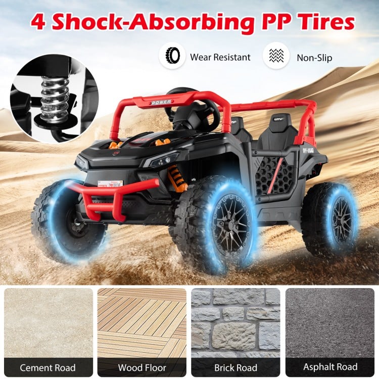 4 shock-absorbing PP tires on a black 12V kids ride-on truck, designed for smooth off-road driving and safety.