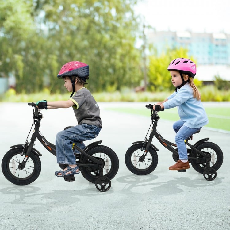 Kids riding 12-inch black bikes with removable training wheels, adjustable seats, and safety features for ages 3-8.