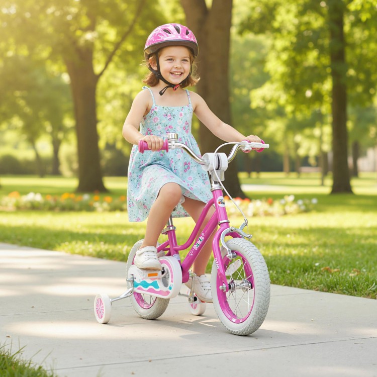 A girl riding a pink 12-inch kids bike with training wheels, designed for ages 3-8, in a sunny park setting.