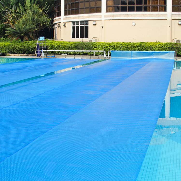 Rectangle swimming pool cover in blue, 12-mil thick PE, designed to retain heat and minimize evaporation for pool.