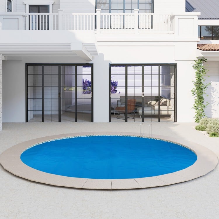 Round 12ft x 30in above ground swimming pool with a protective cover, designed to retain heat and reduce debris.