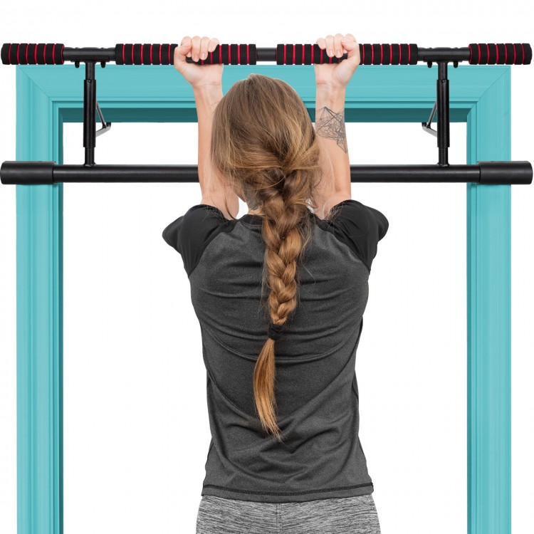 Foldable pull-up bar with foam grip, shown in use for chin-ups, designed for home gym and door frame compatibility.