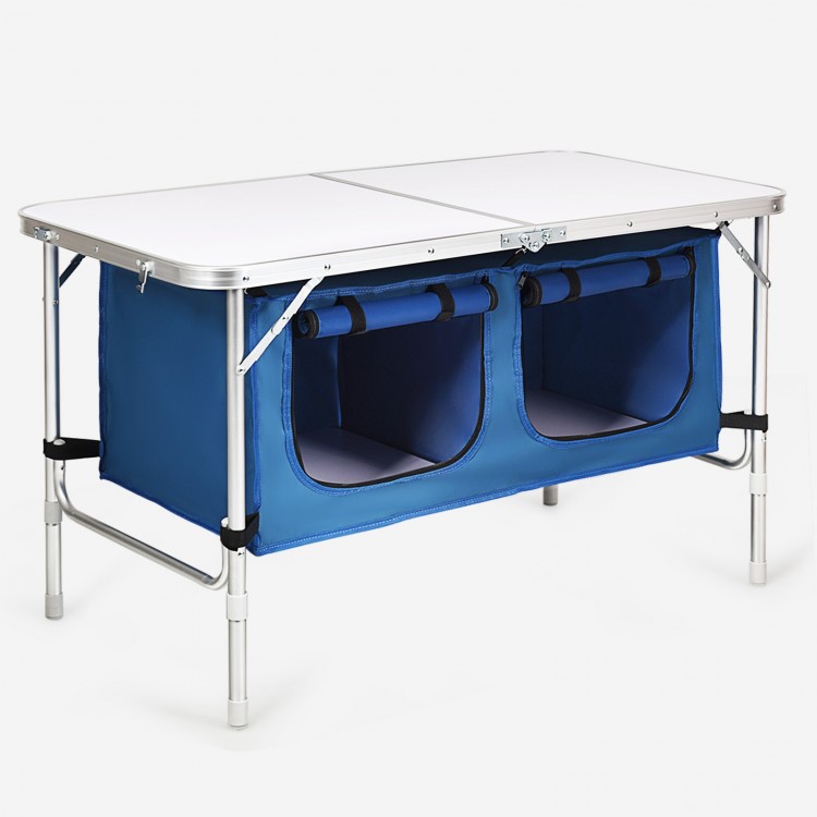 Height adjustable folding camping table in blue with large storage area, designed for easy transport and stability.