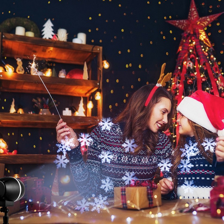 Outdoor waterproof Christmas snowflake LED projector lights creating snow flurries, perfect for festive decorations.