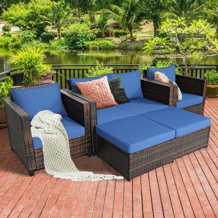 Navy cushioned rattan armchair from the 5-piece set, designed for comfort and style in outdoor spaces.