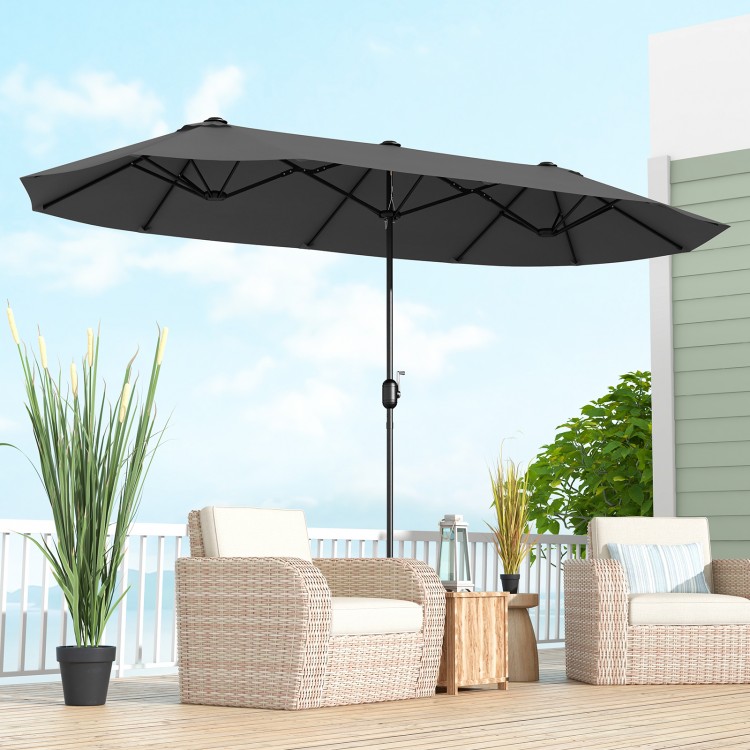 Double-sided 13 feet patio umbrella in gray with crank handle, providing ample shade for outdoor seating areas.