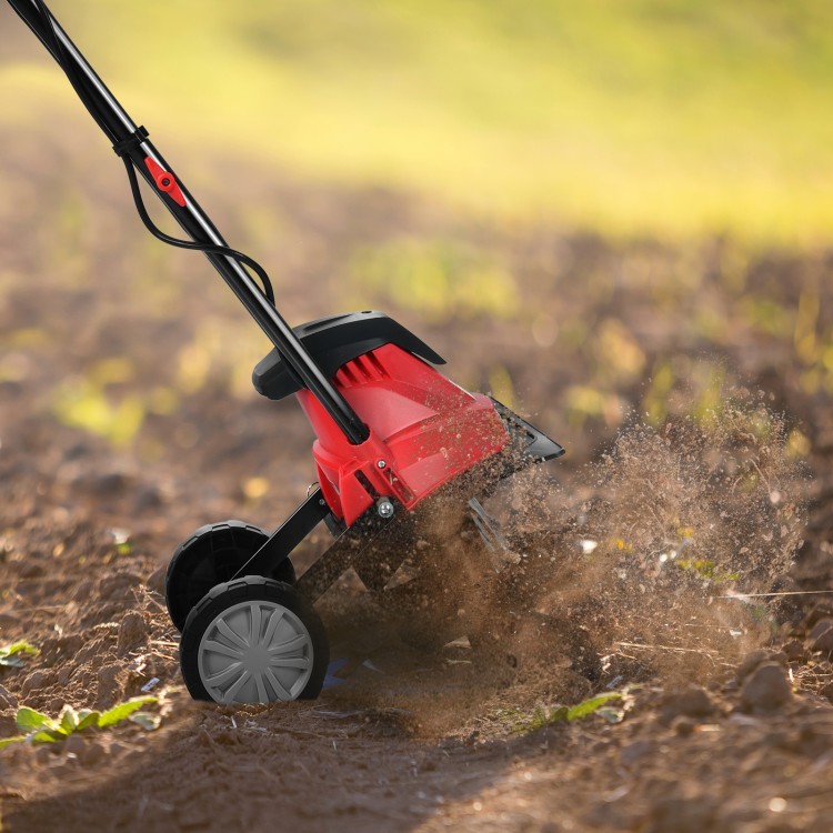 14-inch electric tiller with 10-amp motor, cultivating soil in a garden, ideal for small to medium-sized spaces.