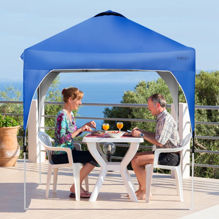 Blue 6.6 x 6.6 FT pop-up canopy tent with adjustable height, providing shade for outdoor activities on a patio.