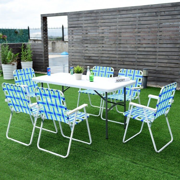 Folding beach chairs in blue webbing with a steel frame, set around a table for outdoor gatherings.