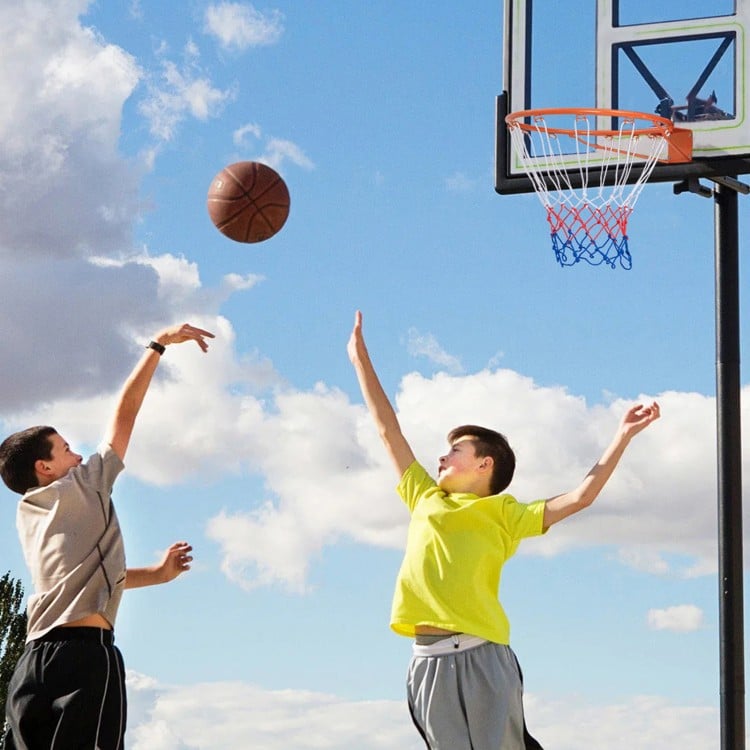 15-inch basketball rim with all-weather net, shown in use outdoors, perfect for versatile indoor and outdoor play.