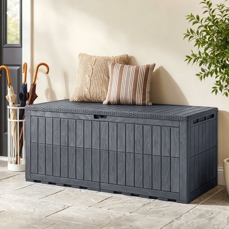 Gray 180 Gal outdoor deck box with lid and handles, serving as storage and extra bench for outdoor gatherings.