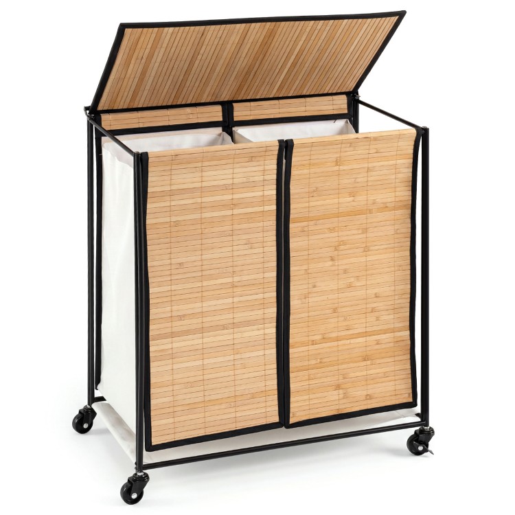 Two-section laundry hamper with lid, bamboo slats, and lockable wheels for easy sorting and mobility.