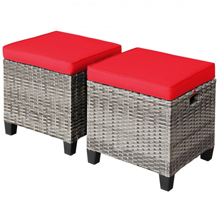 Set of two outdoor rattan ottomans with red removable cushions, perfect for patio or poolside relaxation.