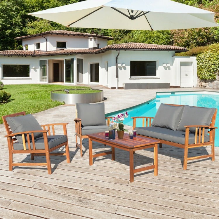 Wooden patio furniture set featuring a loveseat, two chairs, and a table with soft cushions, ideal for outdoor.