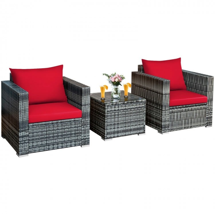 Two cushioned red chairs and a glass-topped table in a 3-piece patio rattan furniture set for outdoor relaxation.