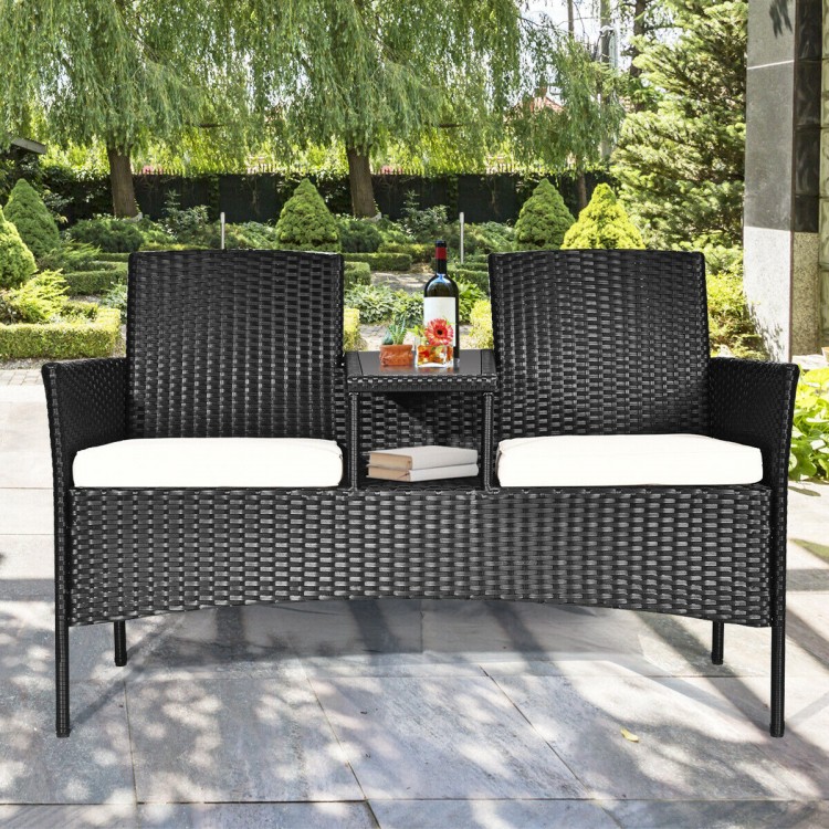 Wicker patio conversation set with removable cushions, featuring a durable steel frame and tempered glass table, ideal.