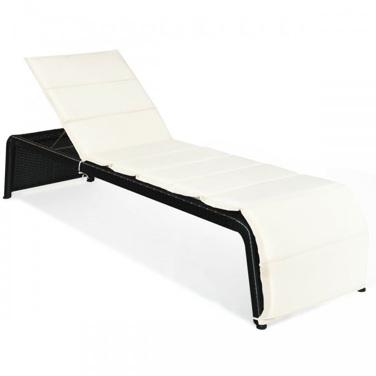 Adjustable patio rattan lounge chair in white with removable cushion, perfect for outdoor relaxation by the pool or.