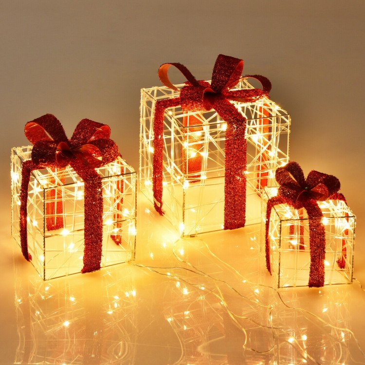 Three lighted gift box decorations with red ribbons and 60 LED lights, perfect for indoor and outdoor Christmas.