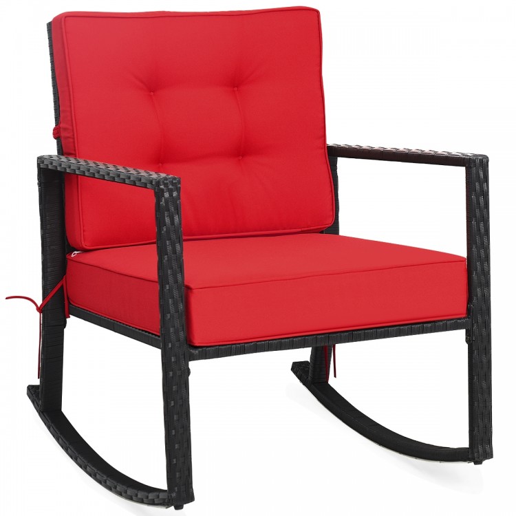Red cushioned patio rattan rocking chair with sturdy metal frame, perfect for outdoor relaxation in garden or backyard.