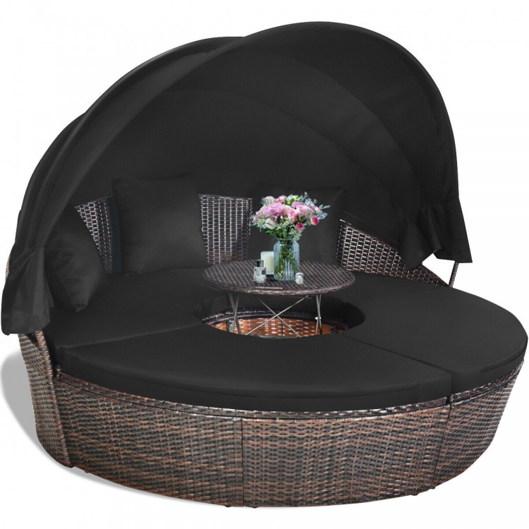 Black outdoor daybed with a retractable canopy and soft cushions, featuring a round design ideal for versatile patio.