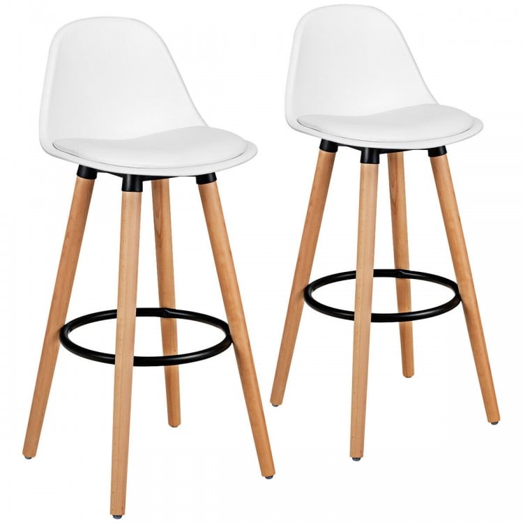 Set of two white mid-century barstools with beech wood legs and metal footrest, perfect for dining or home bars.