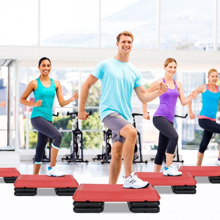 Adjustable red aerobic stepper platform with risers for varied workout intensity, ideal for home and gym exercises.