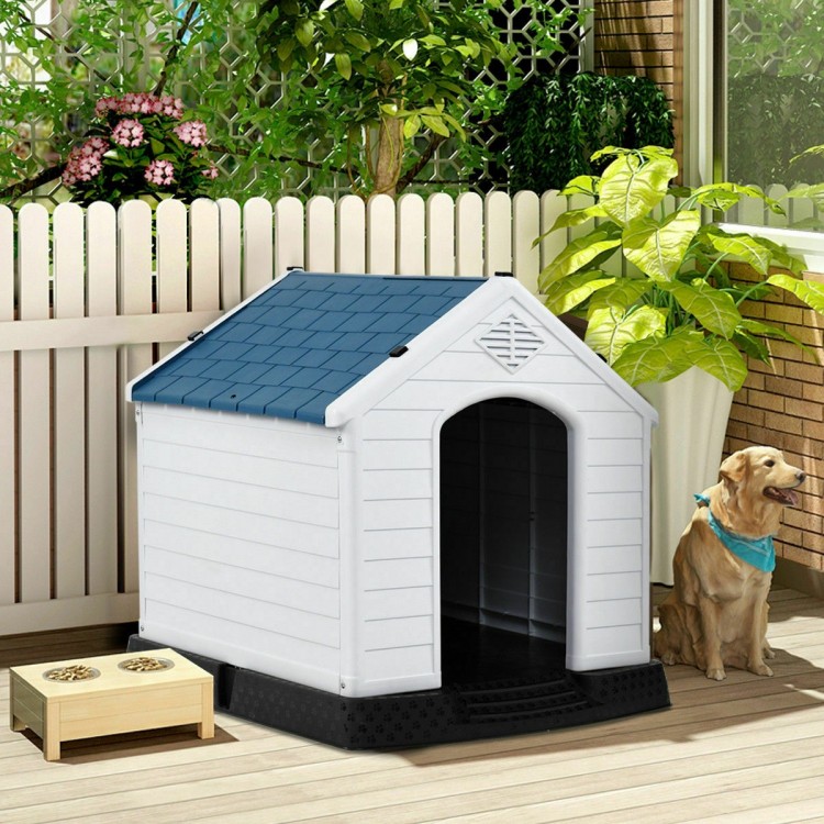Durable plastic dog house with a blue roof, providing shelter and comfort for pets in outdoor settings.