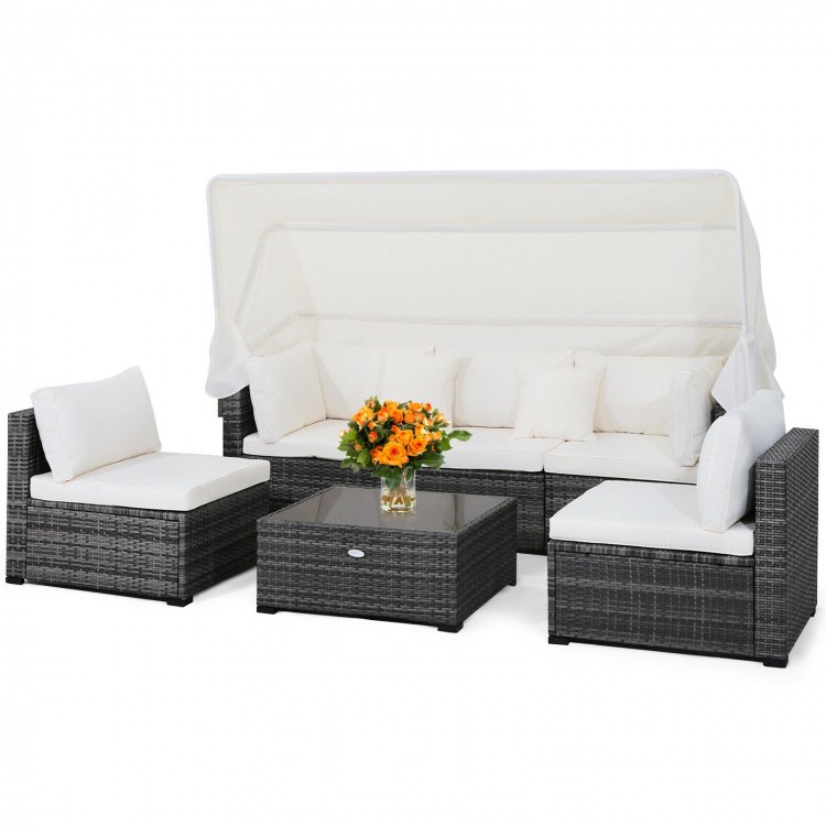 6-piece patio rattan furniture set with retractable canopy, featuring padded cushions and a glass tabletop for outdoor.