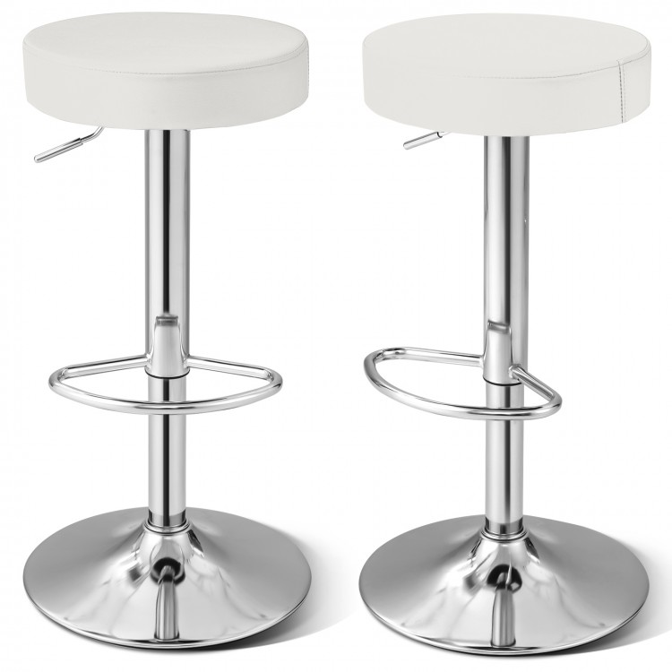 Close-up of the white PU leather seat of a swivel barstool with chrome footrest, showcasing its stylish design and.
