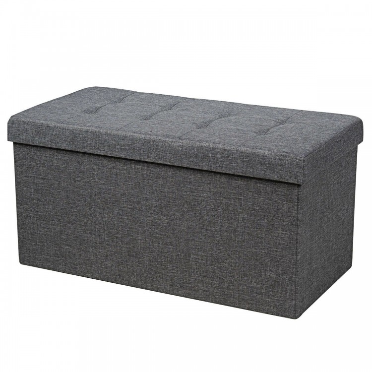 Foldable dark gray storage ottoman with padded seat, sturdy MDF frame, and roomy interior for blankets and clothes.