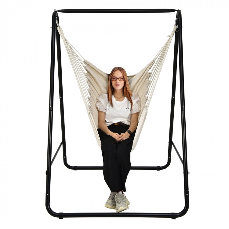 Hanging padded hammock chair with stand in beige, featuring a sturdy steel frame for indoor or outdoor use.