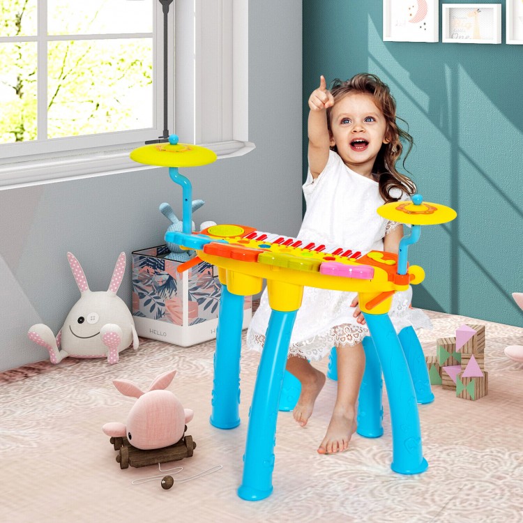 Colorful 24-key piano keyboard with drum set, microphone, and stool, designed for kids' fun and musical practice.
