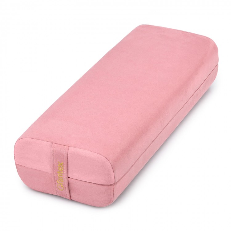 Yoga bolster pillow in pink with a washable cover and carry handle, designed for comfort and support during yoga.