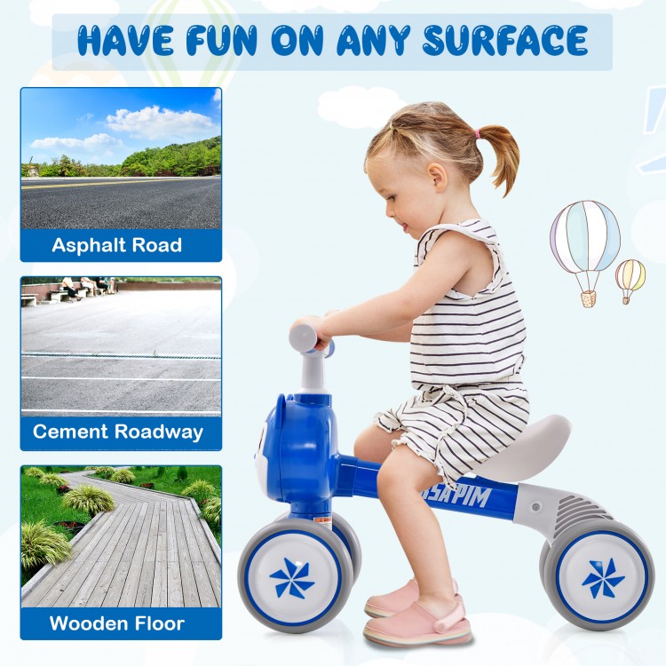 Blue baby balance bike with four wheels, featuring a carbon steel frame and noiseless EVA wheels for safe riding.