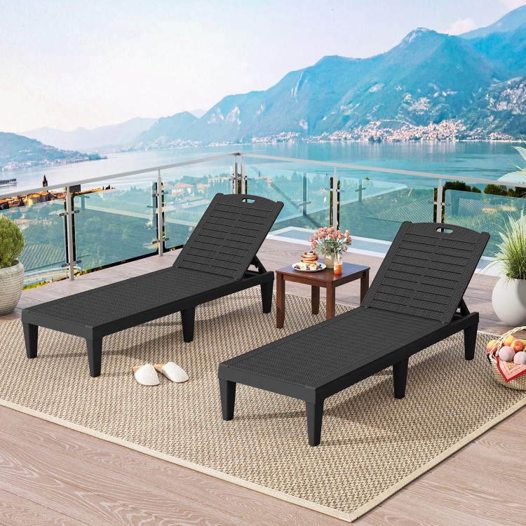 Two black outdoor PP chaise lounge chairs with adjustable backrests, perfect for poolside relaxation and sunbathing.
