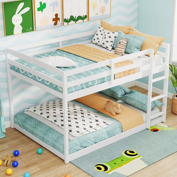 Full over full low-to-ground bunk bed in white with guardrails and integrated ladder, ideal for kids' rooms.