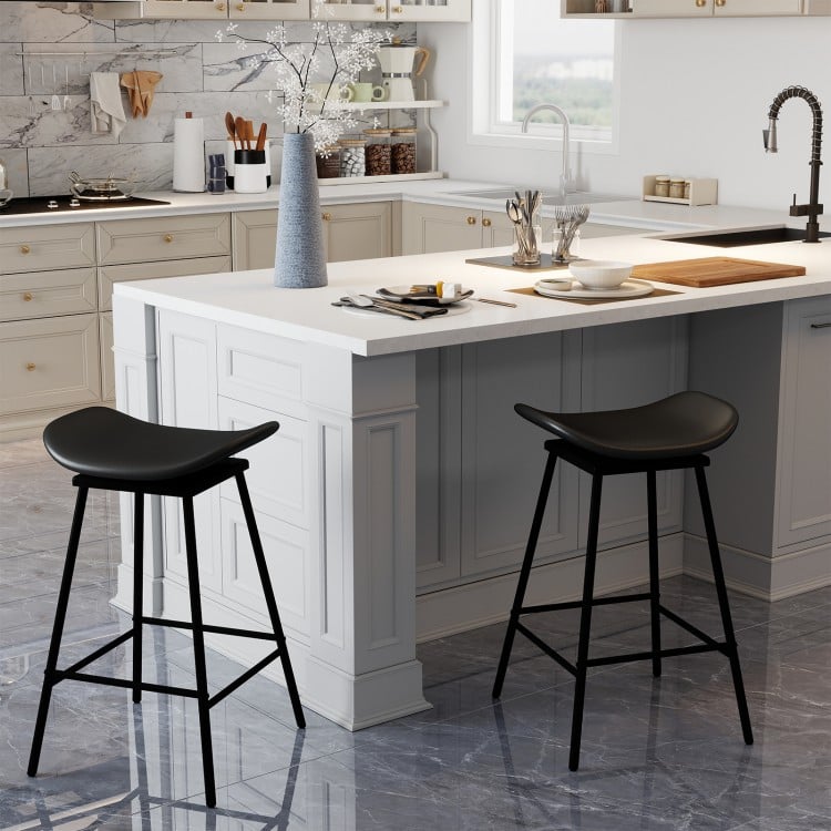 Set of 2 black swivel barstools with faux leather upholstery and footrest, ideal for kitchen islands or home bars.