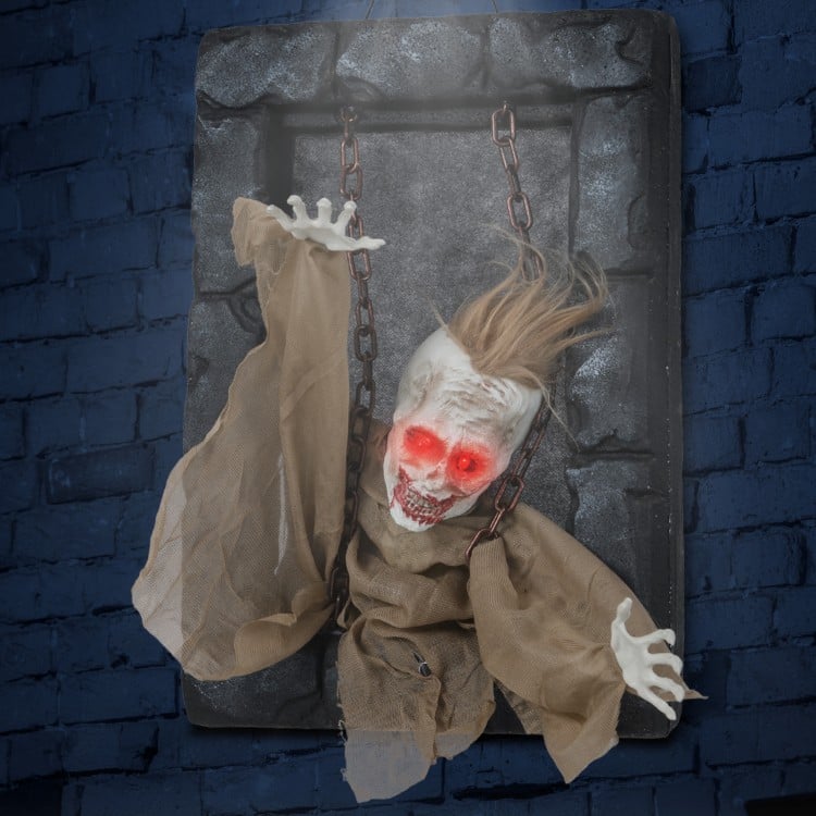 Hanging animated zombie prisoner decoration with glowing red eyes, sound activation, and detailed features for.