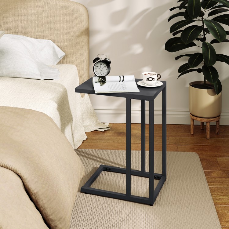 C-shaped side table in dark gray with a spacious tabletop, ideal for snacks and drinks beside a bed or couch.