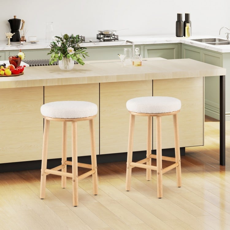 Set of 2 upholstered 27" bar stools with boucle fabric seats and rubber wood frames, ideal for kitchen islands or.