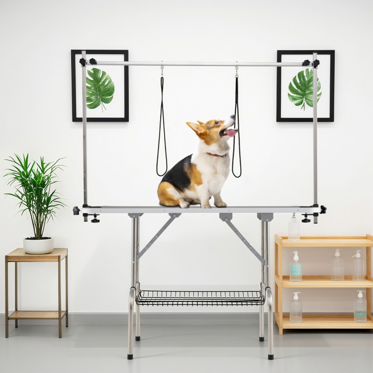 Foldable dog grooming table with height adjustable arms, sturdy frame, and non-slip waterproof surface for pet care.