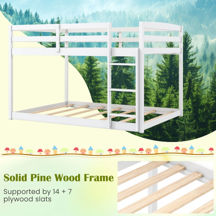 Full over full low-to-ground bunk bed in white, featuring a solid pine wood frame and safety guardrails for kids.