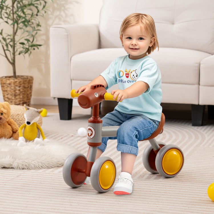 Toddler riding a brown baby balance bike with a cute horse head design, featuring EVA foam wheels for safe indoor and.